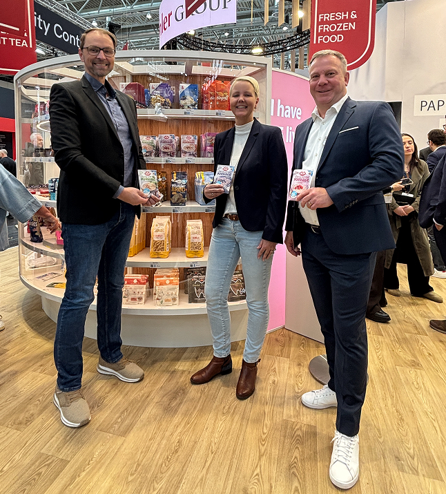 Porridge mit Beeren garniert in einer wei&szlig;en Sch&uuml;ssel vor wei&szlig;em Grund.