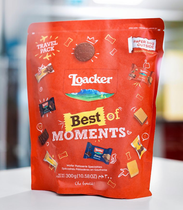 Red Loacker Best of Moments bag on white surface featuring assorted wafer bars and small snacks in a compact travel pack