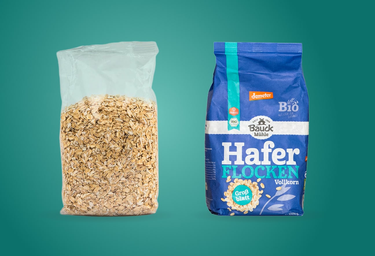 Clear oat flakes bag and blue wholegrain oat flakes package placed side by side against a green background layout view