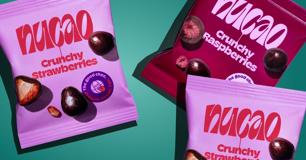 Colorful nucao snack packs for almonds, strawberries and other mixes scattered on a teal background with nuts and fruits.